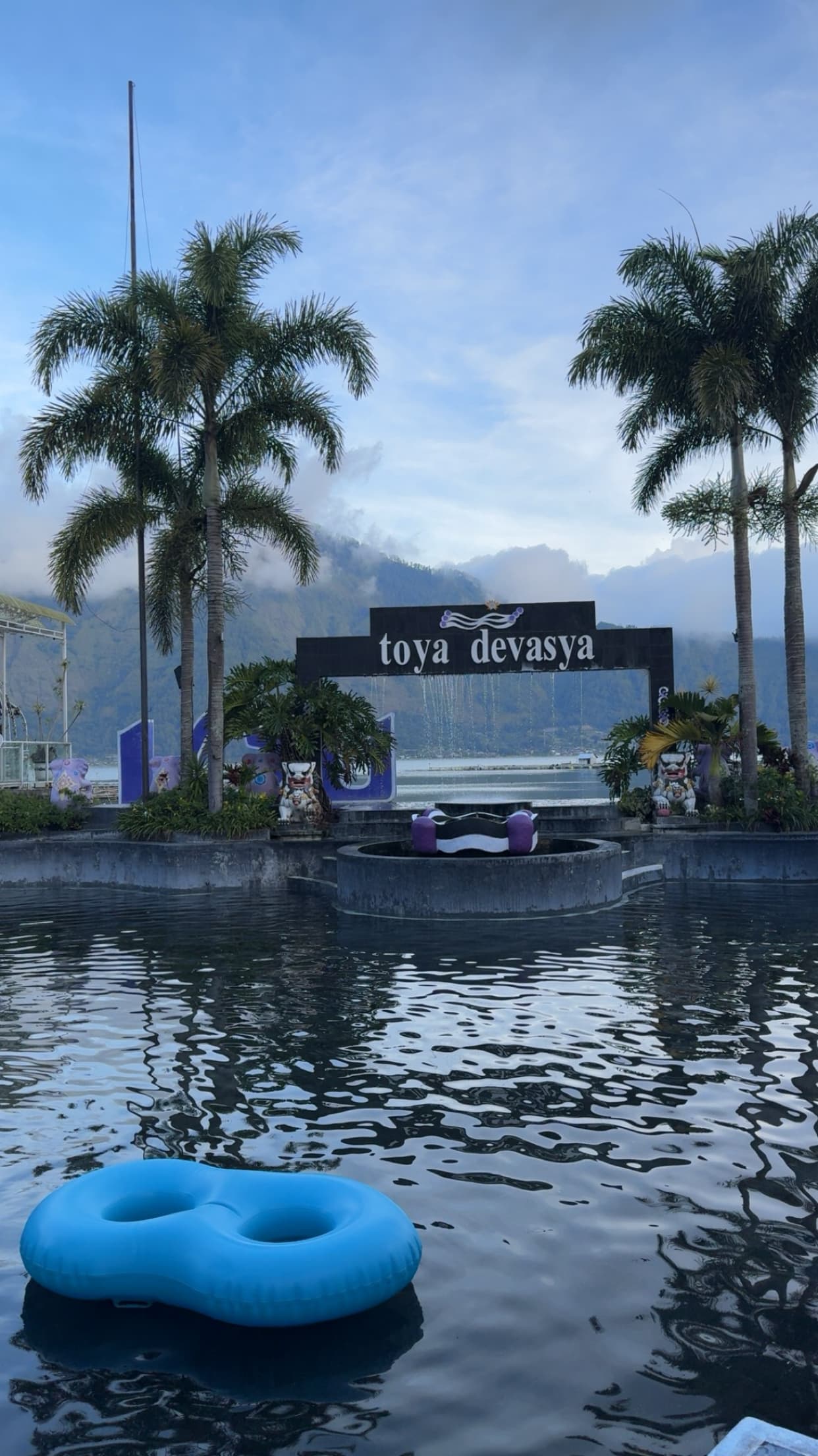 Toya Devasya Geopark hot spring pools in Kintamani with Lake Batur and caldera mountains in the background.
